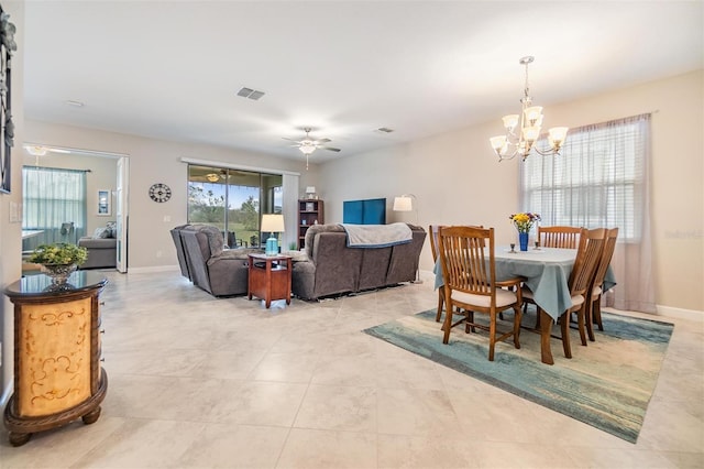 dining area with ceiling fan with notable chandelier