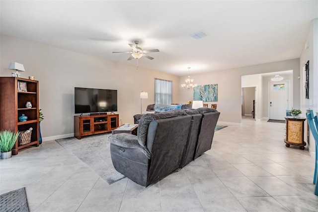 living room with light tile patterned floors and ceiling fan with notable chandelier