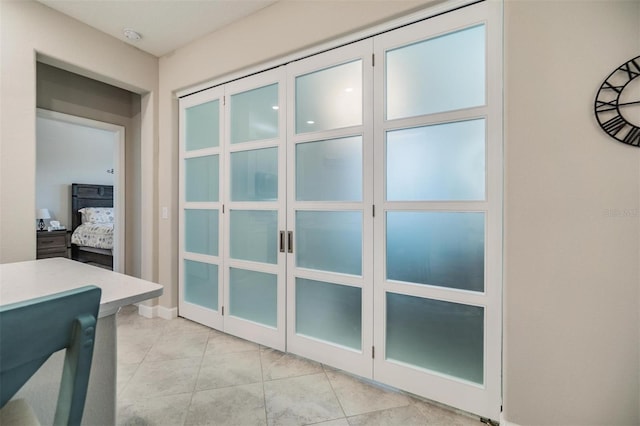 entryway with light tile patterned flooring