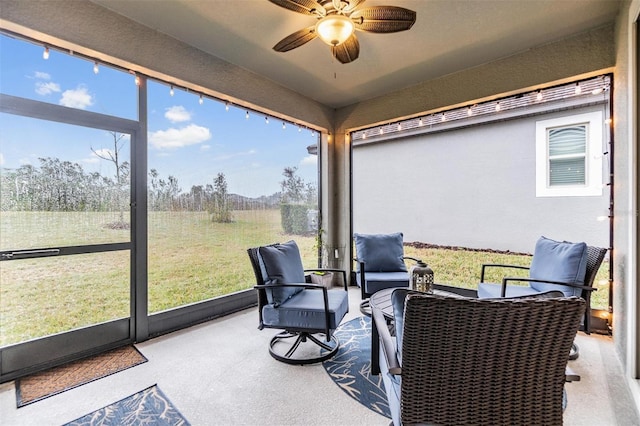 sunroom / solarium featuring ceiling fan