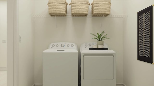 clothes washing area featuring washer and dryer