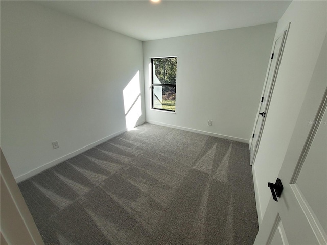 empty room featuring dark colored carpet