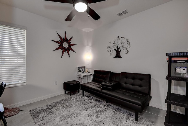 living room with ceiling fan and tile patterned flooring