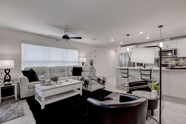 tiled living room with ceiling fan