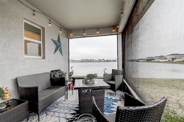 balcony with a water view and a patio area