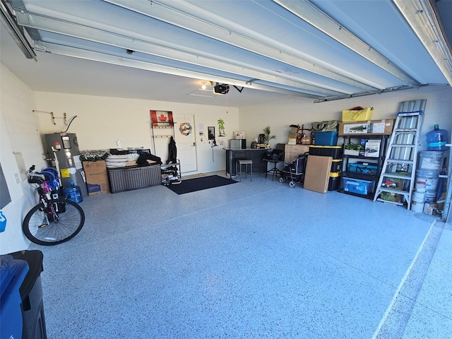 garage with water heater and a garage door opener