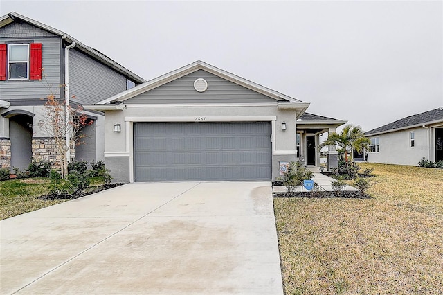 view of front of home featuring a garage and a front lawn