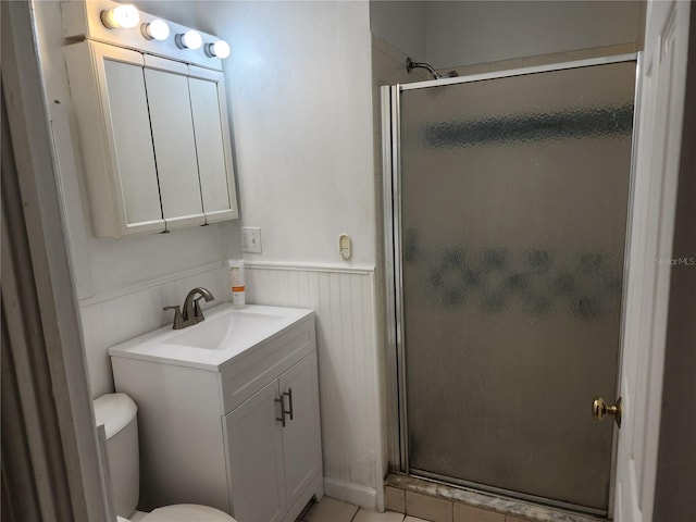 bathroom with walk in shower, vanity, and toilet