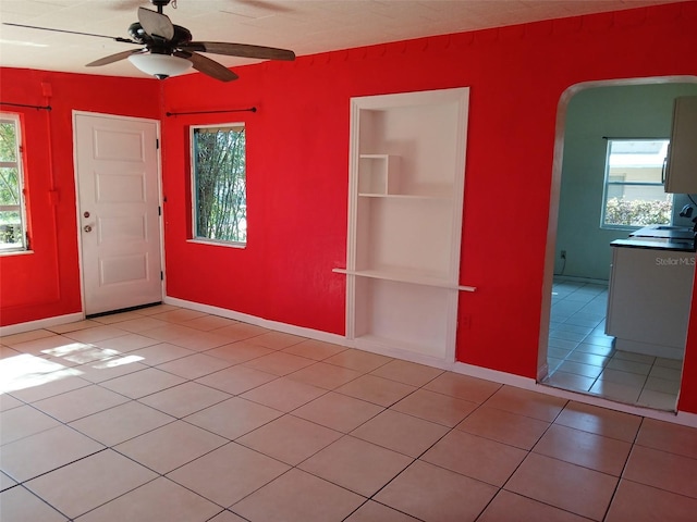 tiled foyer entrance with ceiling fan