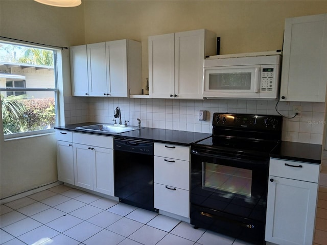 kitchen with sink, plenty of natural light, black appliances, white cabinets, and decorative backsplash