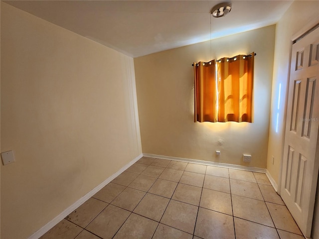 empty room with light tile patterned floors