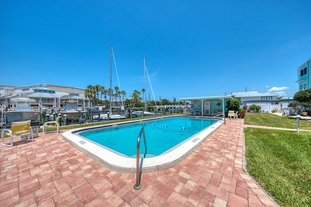 view of swimming pool with a yard and a patio area