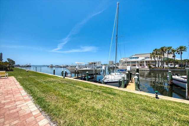 view of dock featuring a water view and a yard