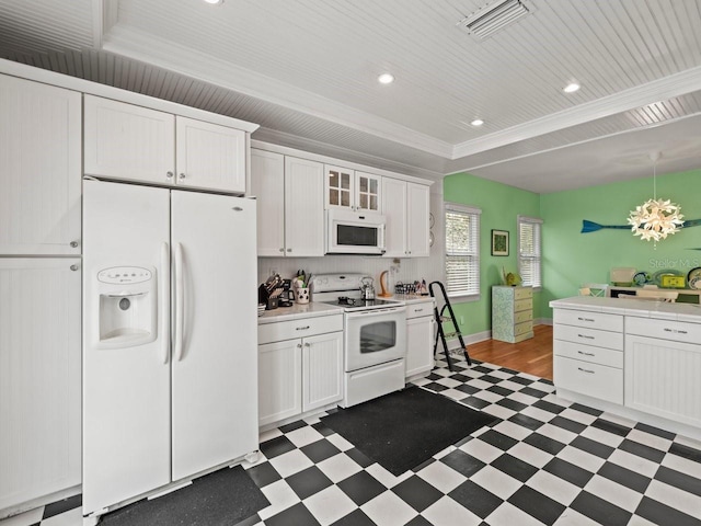 kitchen with white cabinetry, white appliances, crown molding, and an inviting chandelier