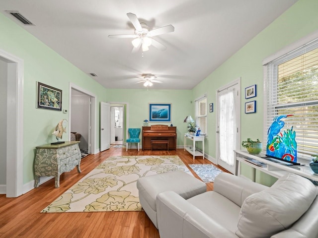 living room featuring light hardwood / wood-style floors and ceiling fan