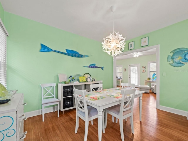 dining area featuring an inviting chandelier and wood-type flooring