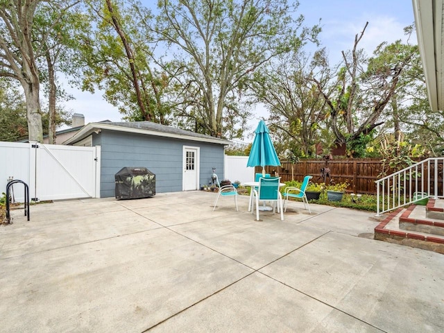 view of patio / terrace with a fenced backyard, a gate, and outdoor dining area