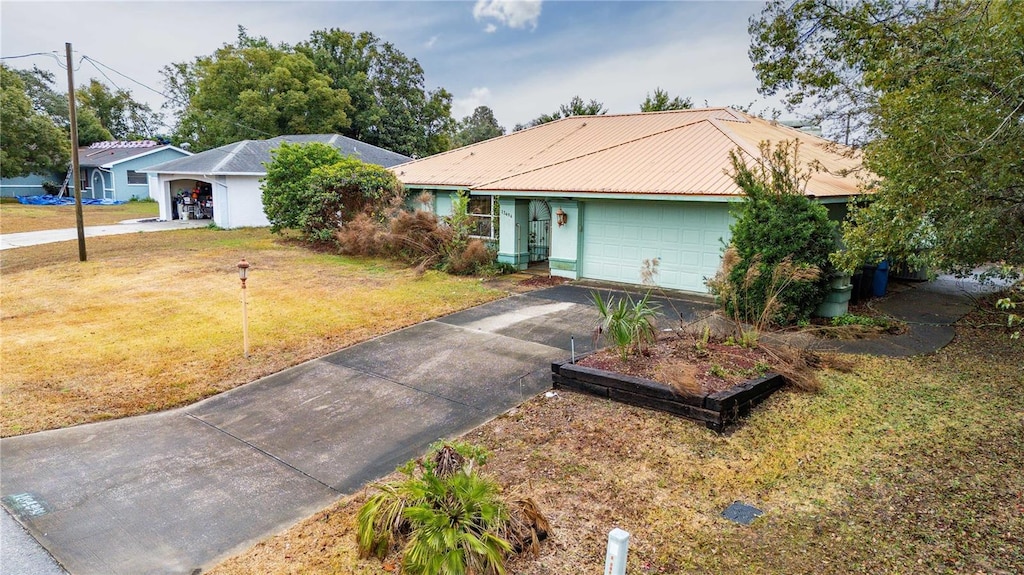 ranch-style home with a garage and a front yard