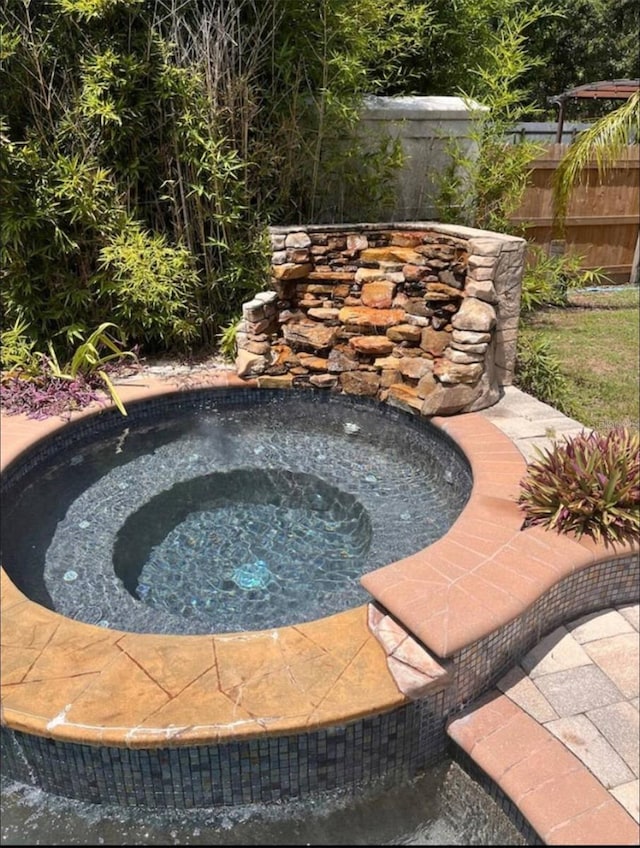 view of pool with an in ground hot tub