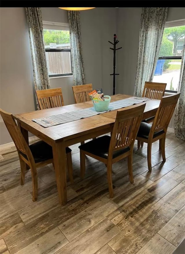 dining area with plenty of natural light and light wood-type flooring