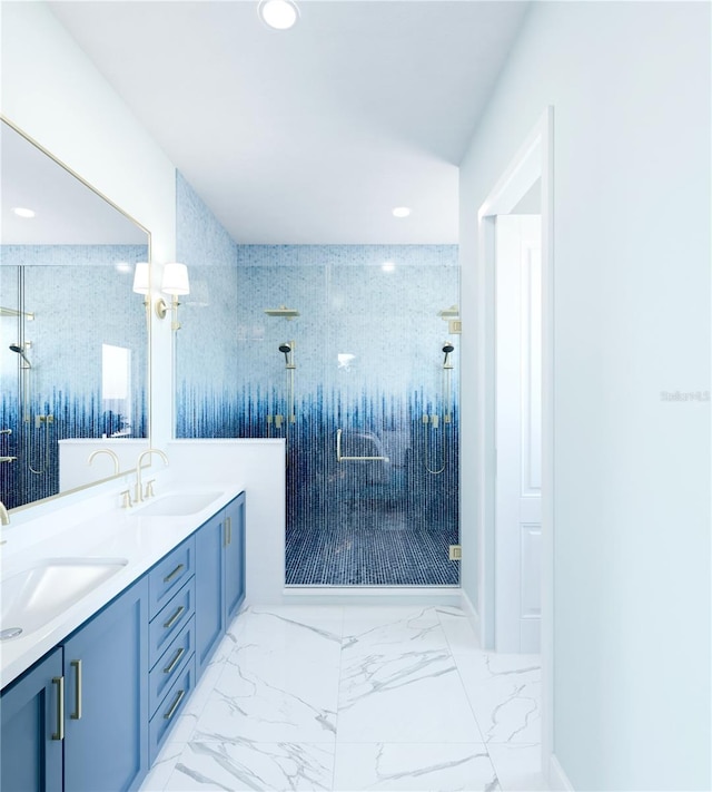 bathroom featuring marble finish floor, a sink, a shower stall, and double vanity