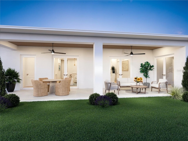 rear view of house featuring stucco siding, an outdoor hangout area, a patio, and french doors