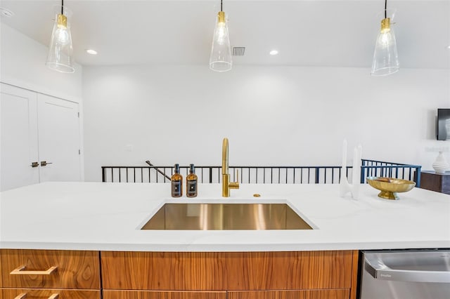 kitchen featuring pendant lighting, stainless steel dishwasher, and sink