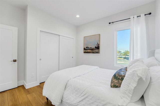 bedroom featuring a closet and light hardwood / wood-style flooring