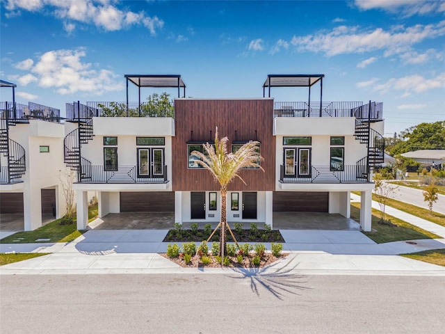 460 87th Ave N, Saint Petersburg, FL 33702 - modern home with driveway, an attached garage, stairway, and stucco siding