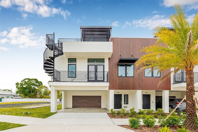 460 87th Ave N, Saint Petersburg, FL 33702 - view of front of home featuring a garage, a balcony, driveway, and stucco siding