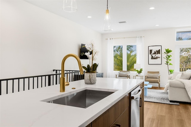 460 87th Ave N, Saint Petersburg, FL 33702 - kitchen with open floor plan, stainless steel dishwasher, a sink, visible vents, and light wood-style flooring