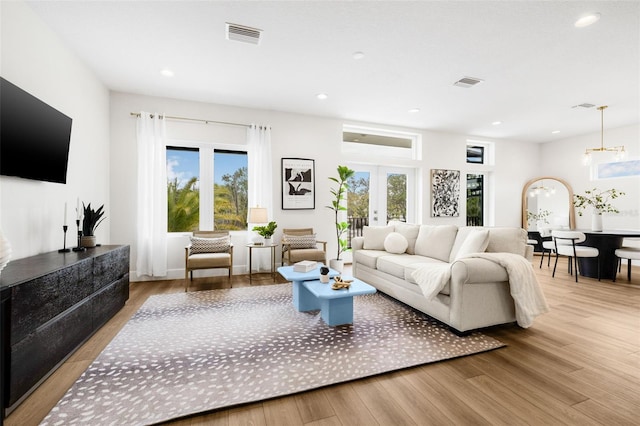 460 87th Ave N, Saint Petersburg, FL 33702 - living area featuring plenty of natural light, visible vents, and wood finished floors
