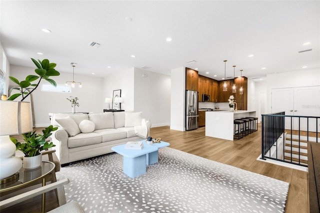 460 87th Ave N, Saint Petersburg, FL 33702 - living room featuring baseboards, visible vents, recessed lighting, and light wood-type flooring