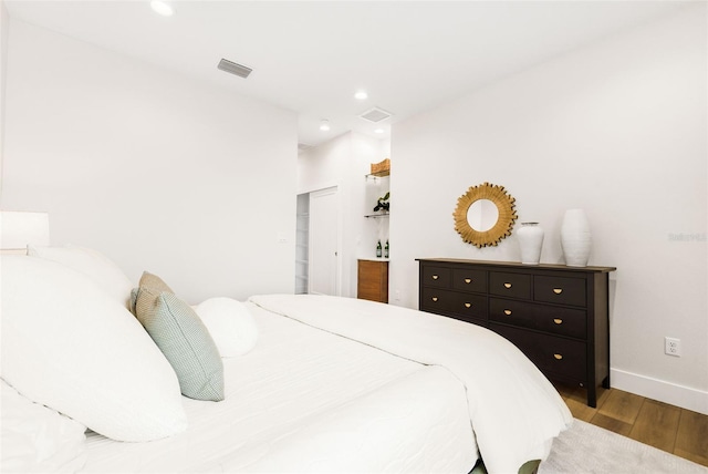 460 87th Ave N, Saint Petersburg, FL 33702 - bedroom featuring a walk in closet, recessed lighting, baseboards, visible vents, and wood finished floors