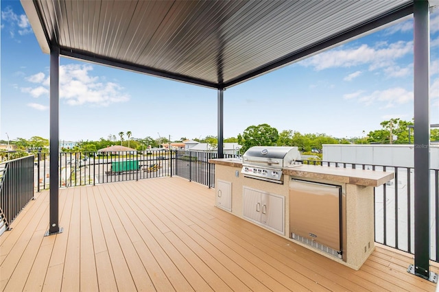 460 87th Ave N, Saint Petersburg, FL 33702 - wooden terrace with grilling area and an outdoor kitchen