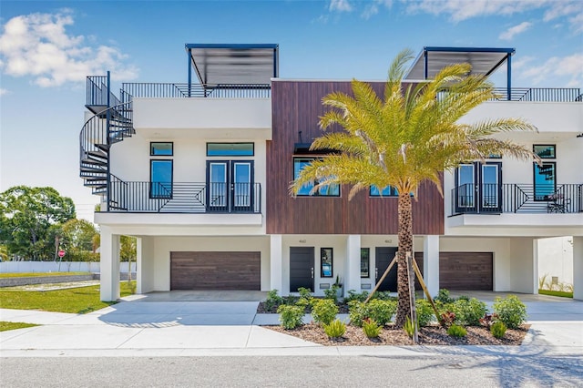 460 87th Ave N, Saint Petersburg, FL 33702 - view of front of property featuring a balcony, concrete driveway, stucco siding, and an attached garage