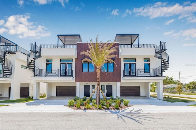 460 87th Ave N, Saint Petersburg, FL 33702 - view of front of property with stairs, stucco siding, an attached garage, and concrete driveway