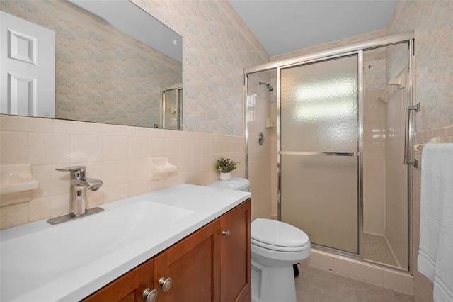 bathroom with walk in shower, tile walls, vanity, and toilet