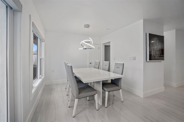 dining area with a wealth of natural light and a chandelier