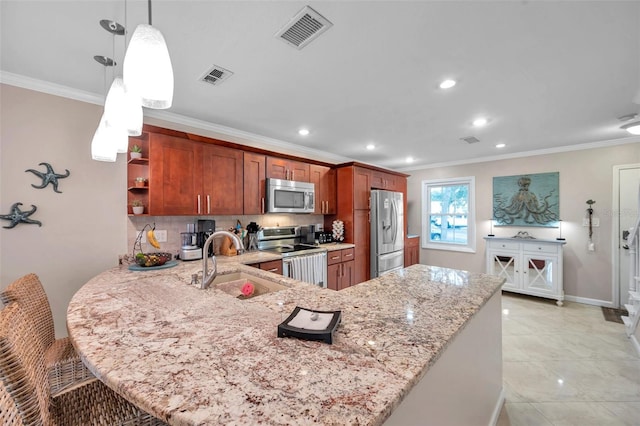 kitchen featuring sink, hanging light fixtures, ornamental molding, appliances with stainless steel finishes, and kitchen peninsula