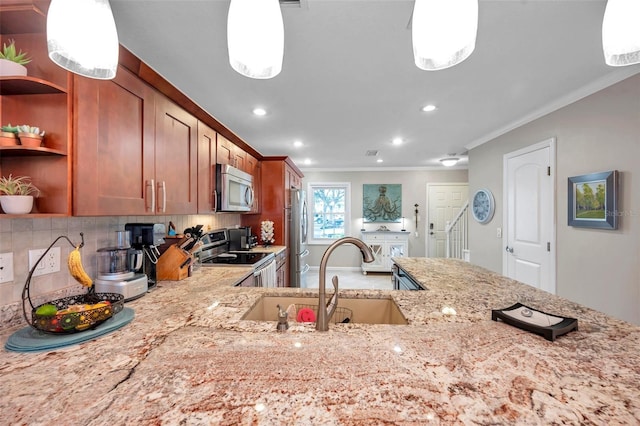 kitchen featuring ornamental molding, appliances with stainless steel finishes, decorative light fixtures, and sink