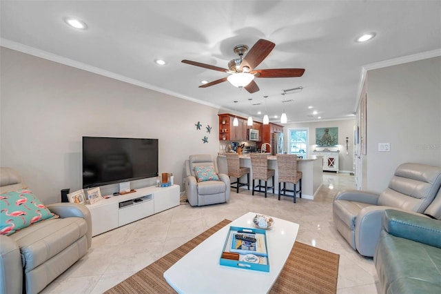 tiled living room featuring ornamental molding and ceiling fan