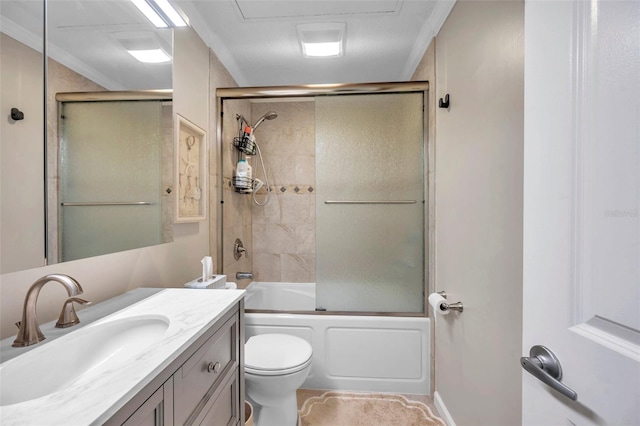 full bathroom featuring crown molding, vanity, bath / shower combo with glass door, and toilet