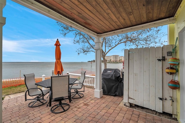 view of patio / terrace with a water view and a grill