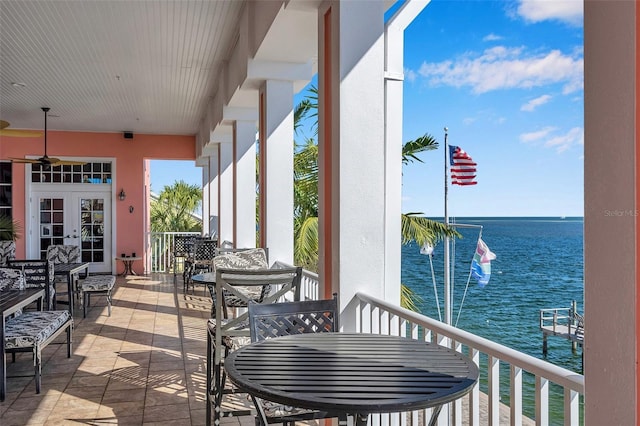 view of patio with a water view and french doors