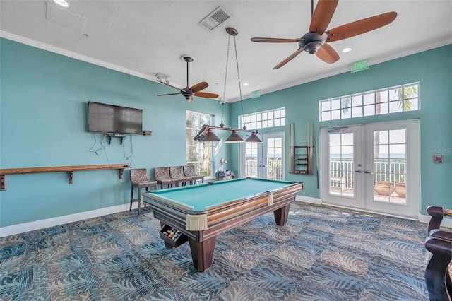 game room featuring french doors, pool table, a textured ceiling, ornamental molding, and carpet