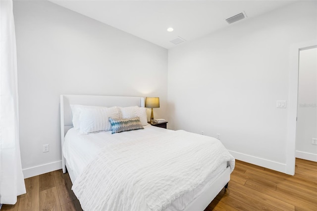 bedroom with hardwood / wood-style floors