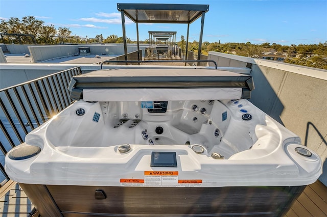 wooden deck featuring a hot tub