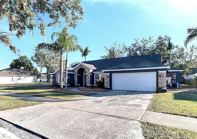 ranch-style home featuring cooling unit, a garage, and a front lawn