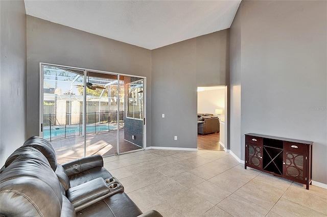 tiled living room with a high ceiling